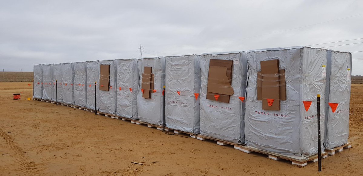 First for more than 400 Tesla PowerPacks arrive on site.
