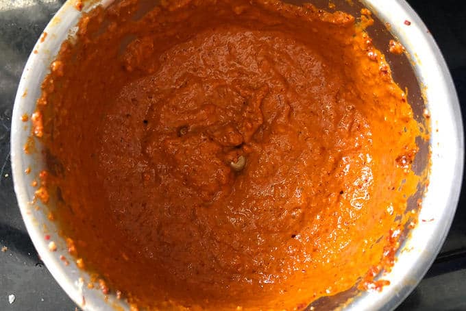 Add the ingredients for ghee roasting in a blender and grind to make a smooth paste. Add little water while grinding. Keep the mixture aside.