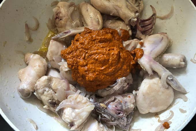 Add the ghee roasted masala paste along with a cup of water and salt and cover and cook the chicken for 15-20 minutes or until almost done.