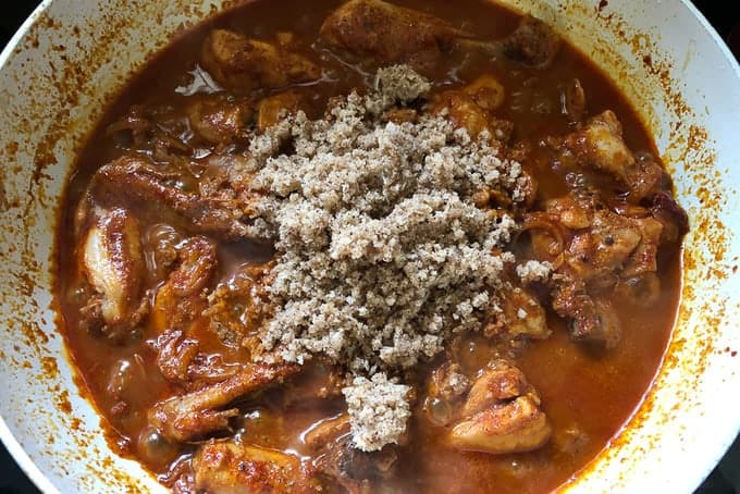 Add the dry roasted masala powder and cook for another 10-12 minutes until the chicken is cooked and the masala is dry.